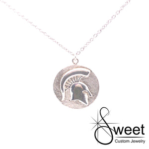Sterling silver pendant with round disk and raised spartan head