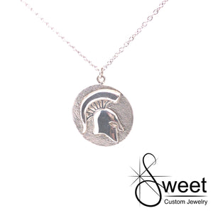Sterling silver pendant with round disk and raised spartan head