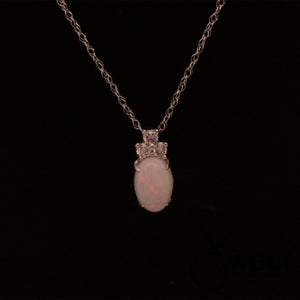 ONE 14KT WHITE GOLD PENDANT FEATURING ONE OVAL SHAPED OPAL