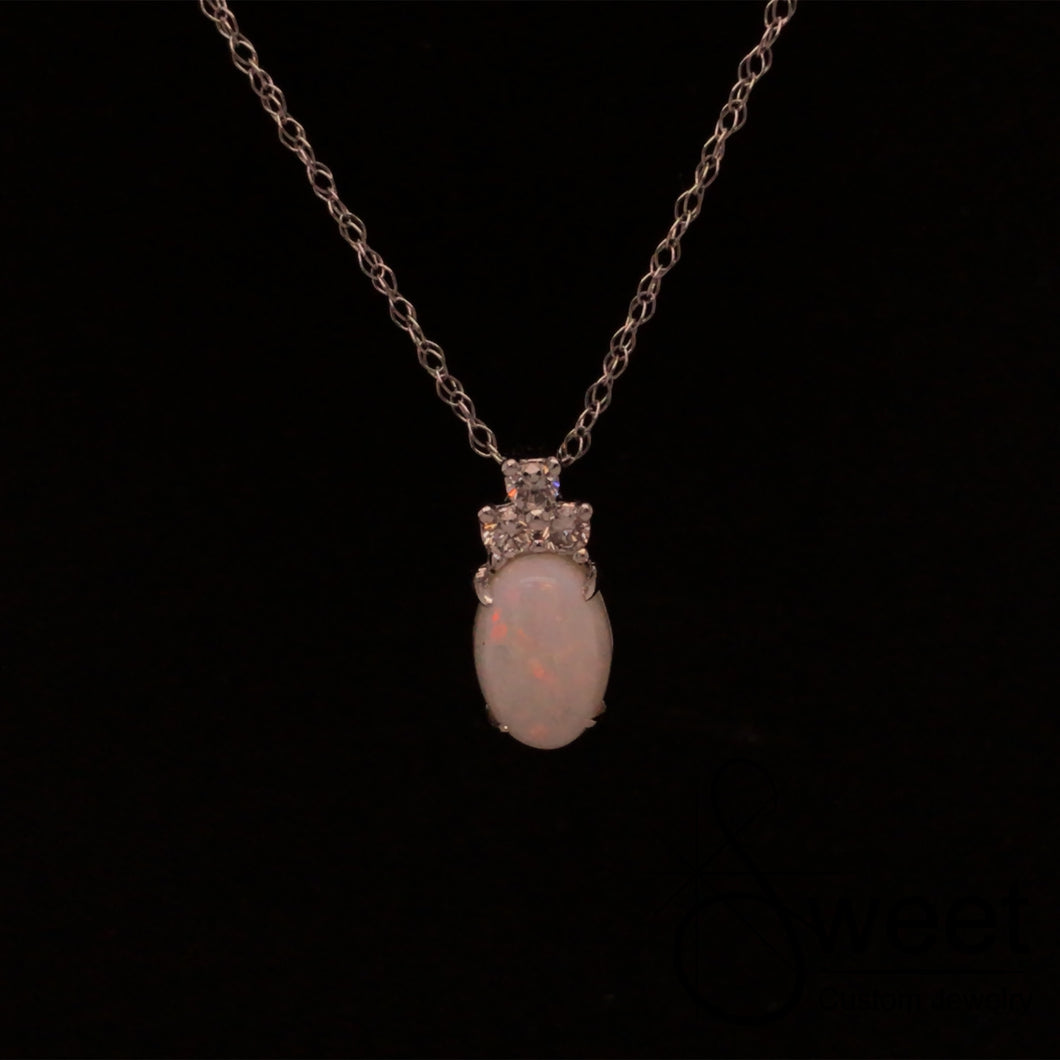 ONE 14KT WHITE GOLD PENDANT FEATURING ONE OVAL SHAPED OPAL