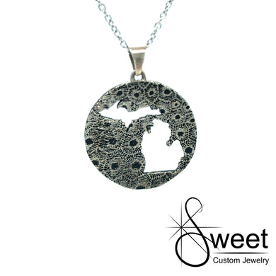 ONE ROUND DISC PETOSKEY STONE PENDANT WITH THE STATE OF MICHIGAN CUT OUT IN THE CENTER,