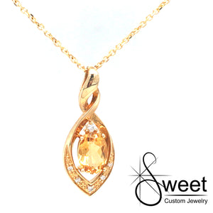 14KT YELLOW GOLD MARQUISE SHAPED TWIST PENDANT FEATURING ONE OVAL SHAPED GENUINE CITRINE