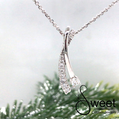 14kt WHITE GOLD TWO ROW PENDANT WITH ONE ROW OF ROUND DIAMONDS AND ONE HIGH POLISHED ROW WITH ONE LARGER ROUND DIAMOND