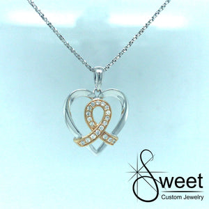 14KT WHITE GOLD HEART SHAPED PENDANT WITH YELLOW GOLD AND DIAMOND RIBBON IN THE CENTER