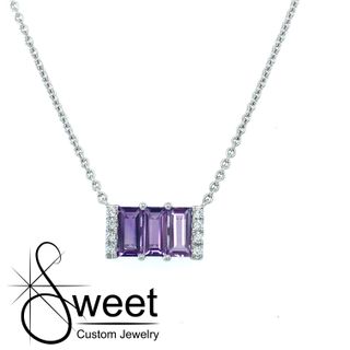 ONE WHITE GOLD AMETHYST PENDANT FEATURING 3 EMERALD CUT AMETHYST  AND .06 CTTW OF DIAMONDS .