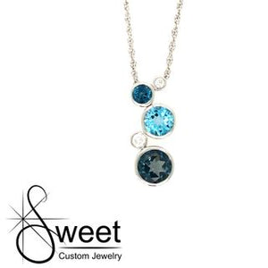 ONE 14KT WHITE GOLD PENDANT FEATURING BEZEL SET SWISS AND LONDON BLUE TOPAZ ACCENTED BY ROUND DIAMONDS