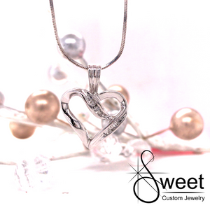 ONE LADIES 10KT WHITE GOLD DIAMOND HEART PENDANT FEATURING BAGUETTE AND ROUND BRILLIANT CUT DIAMONDS, .20CTTW, GH IN COLOR AND SI-I1 IN CLARITY.
